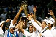 The San Antonio Spurs celebrate with the Larry O'Brien trophy after defeating the Miami Heat to win the 2014 NBA Finals.
